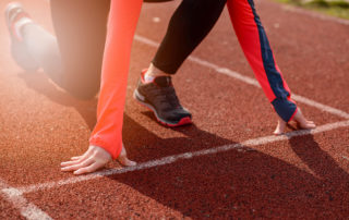 Woman on track in race starting position